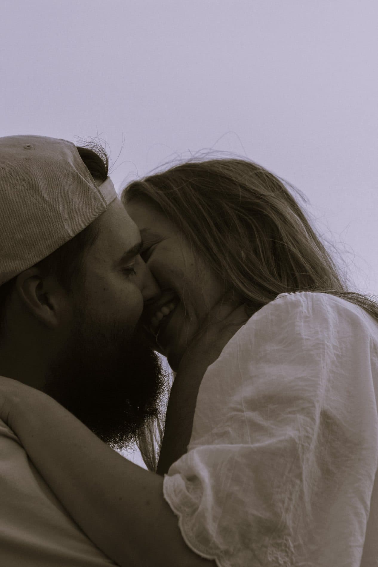 A black and white portrait of a couple close together