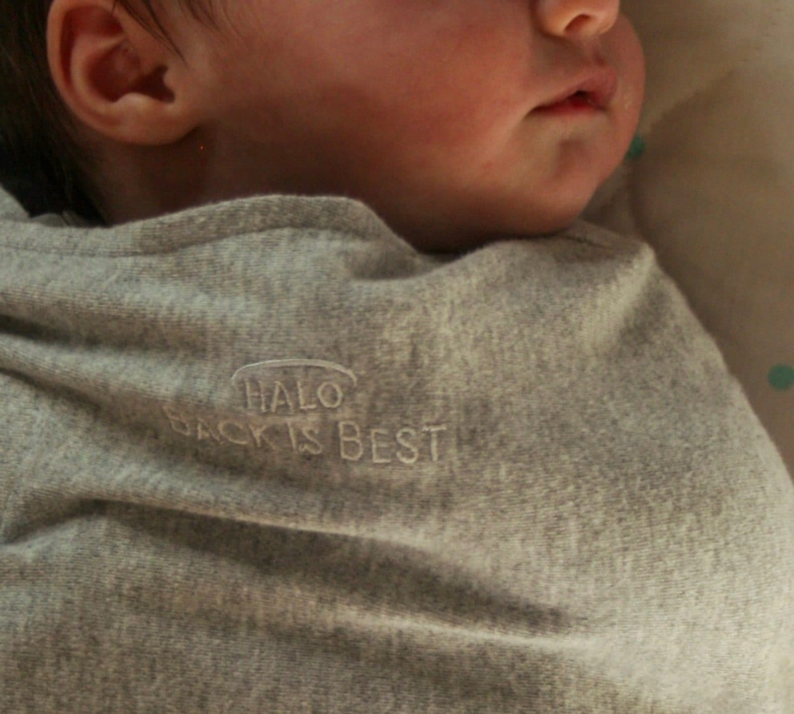 A sleeping newborn wrapped in a soft blanket